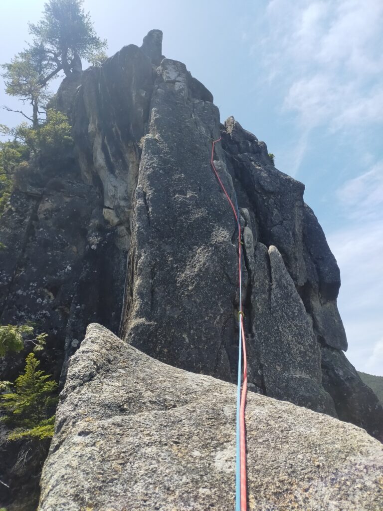 `Climber ascending granite arete Eboshi Rock pitch 8