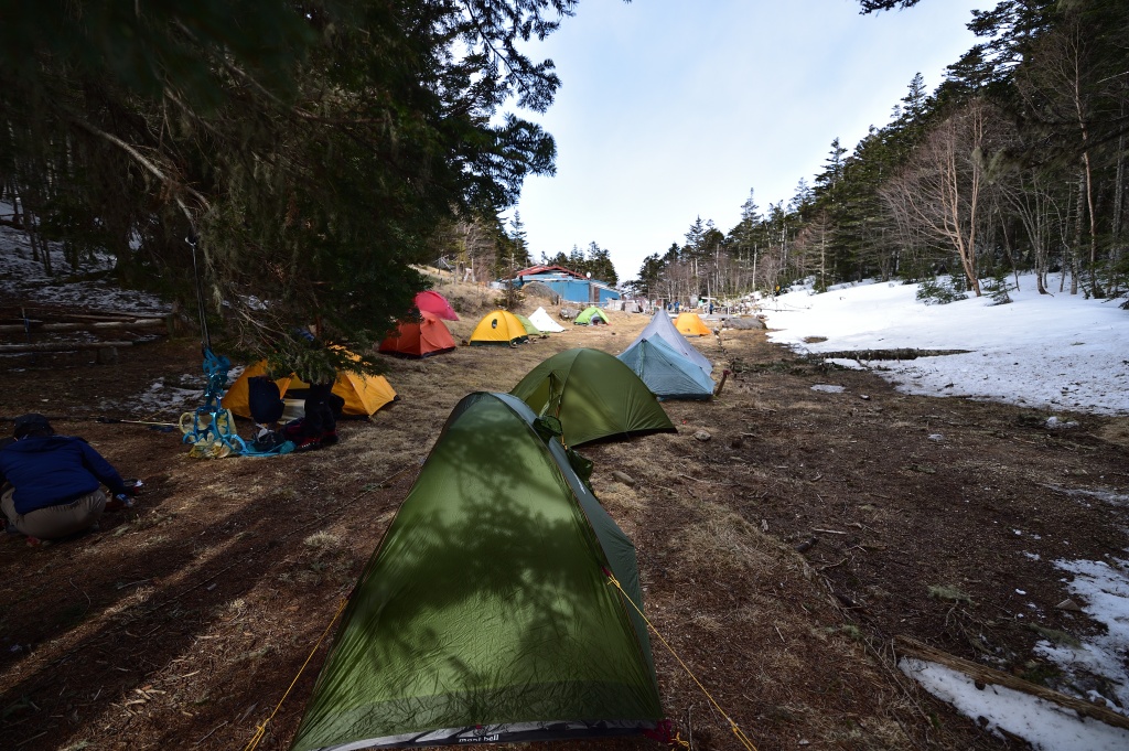 Tent covered with fresh snow at Minami-Omuro Hut campsite during May snowfall in Southern Alps