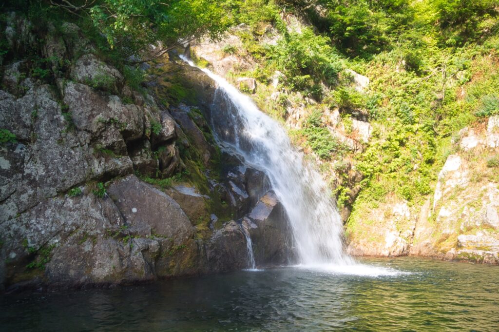 Steep scree slope bypass above waterfall, dangerous terrain in Nanatakisawa Japan