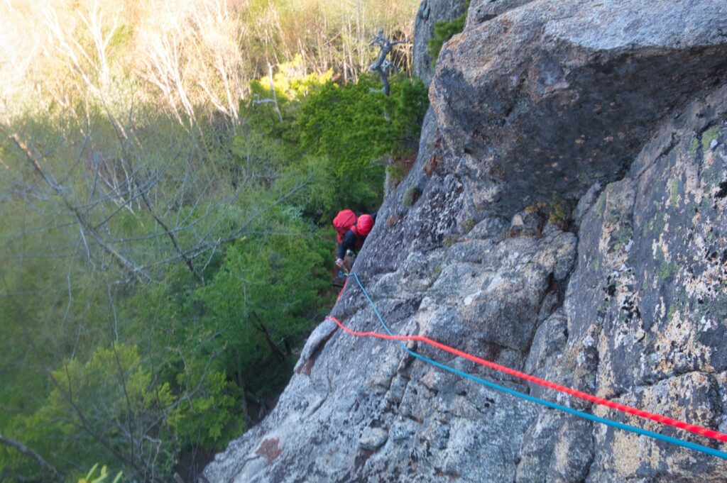 Climbers gearing up Eboshi Rock base trad climbing