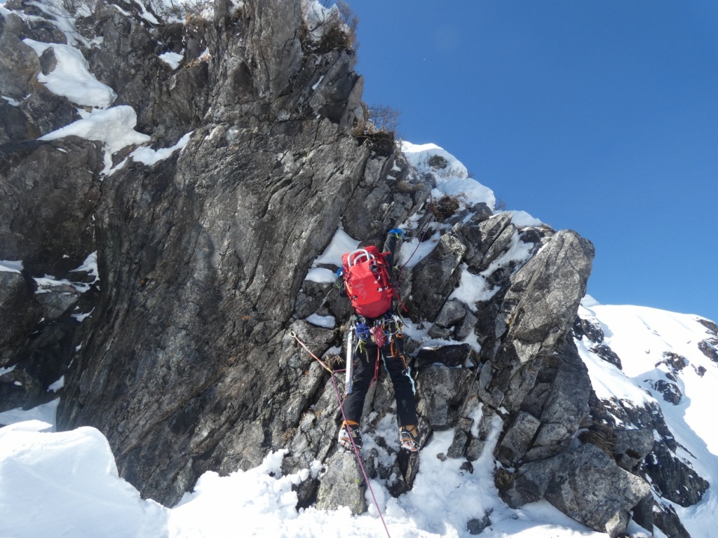 Climbers ascending rock pinnacle on Tanigawa East Ridge winter route