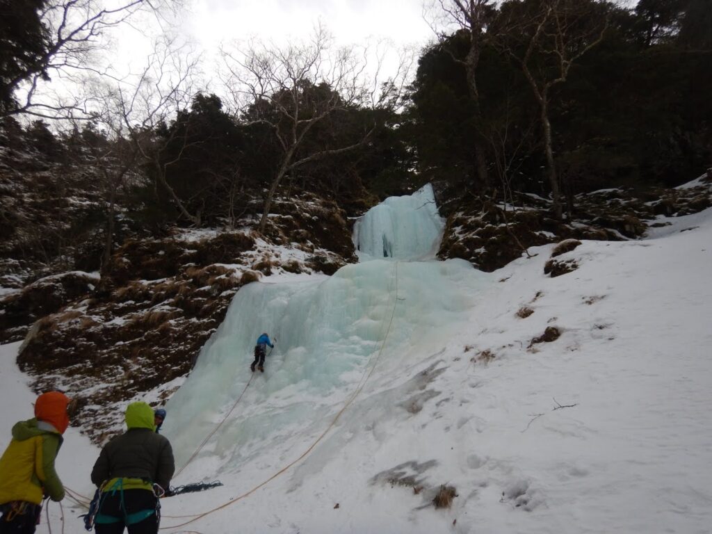 Climber on first pitch Christmas Runze ice route Japan