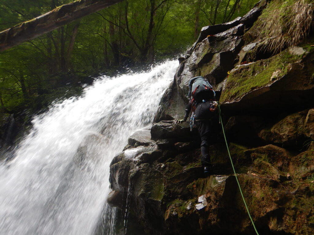 Nisaburo Falls Sukkan-zawa climber ascending waterfall stream climbing Japan