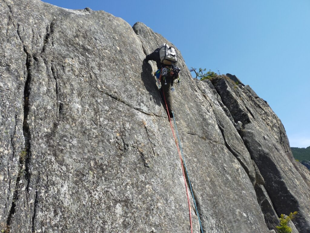 Hand crack climbing Eboshi Rock pitch 13 trad route