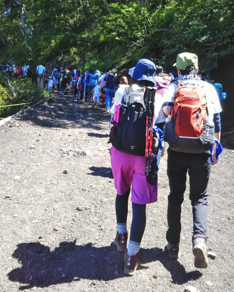 Crowded Mt. Fuji trail near the 5th station gate, illustrating overtourism and the need for new cultural rules.