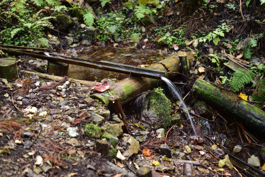 Ono Spring natural mountain spring water emerging from rocks on Mt. Onodake trail, clear potable water source