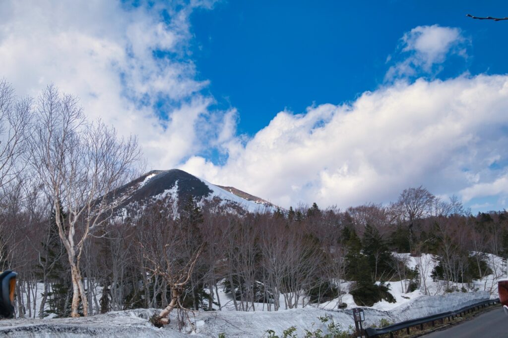 Ski party descending through lower slopes toward Karesawa area after Mt. Takadaodake summit