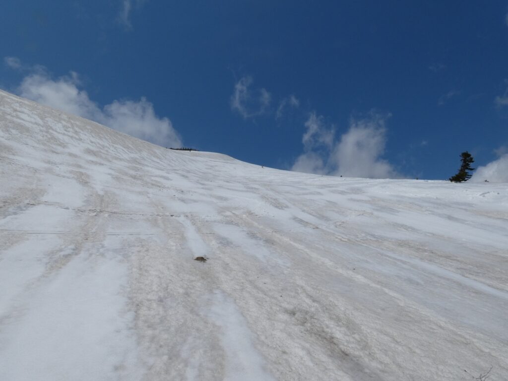Continuation of ski descent on Mt. Takadaodake southeast face with party members following