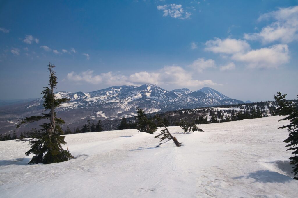 Yokodake summit 1339m in Southern Hakkoda with skiers preparing for north face descent