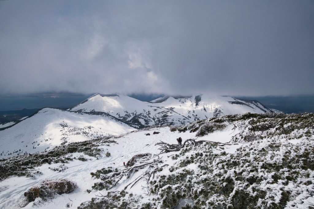 Panoramic view from Mt. Takadaodake summit showing Hakkoda mountain range under spring conditions