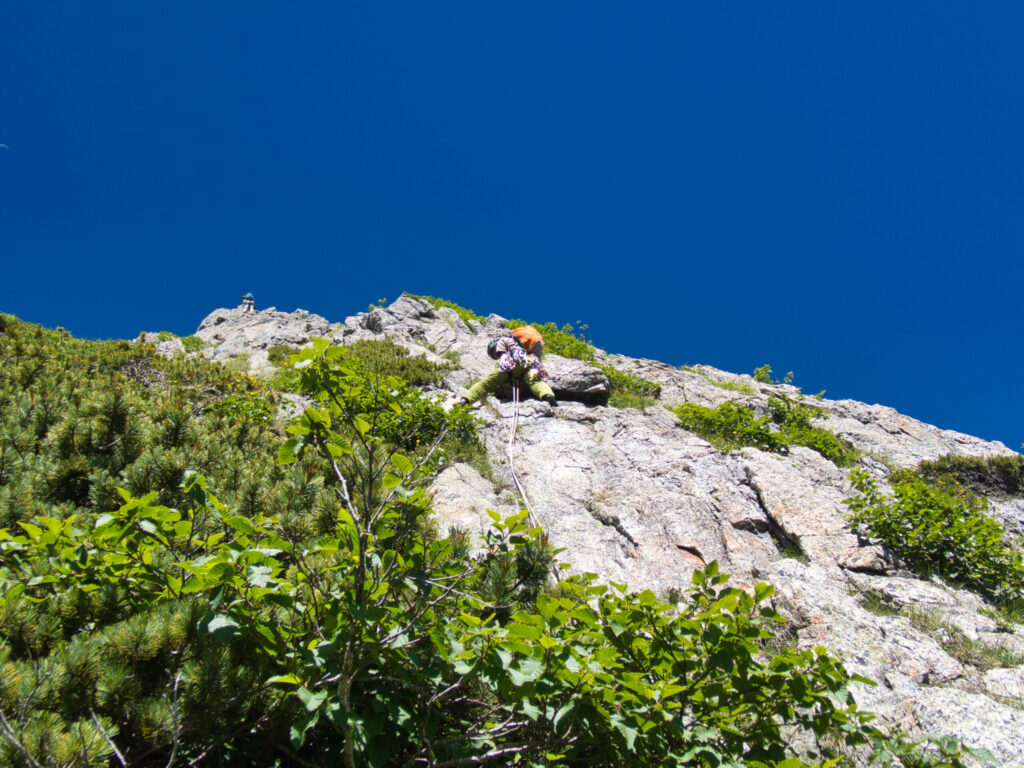Climber on pitch 7 face section Chinne Left Ridge Mt. Tsurugi granite climbing