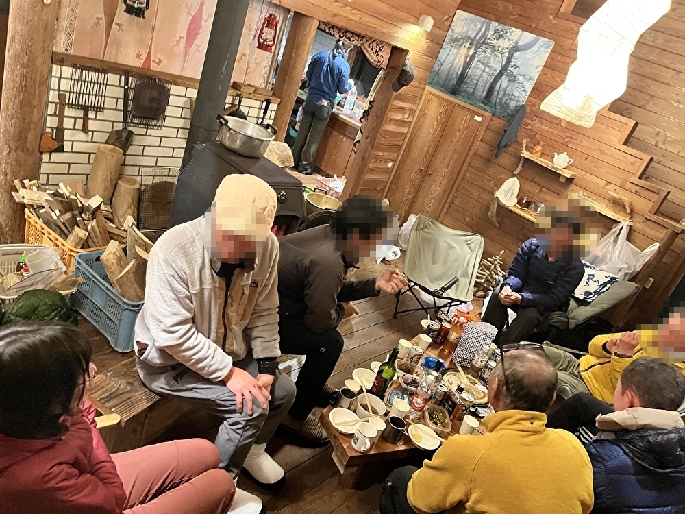 New Year celebration inside Masuzawa Hut with wood stove and climbers gathering