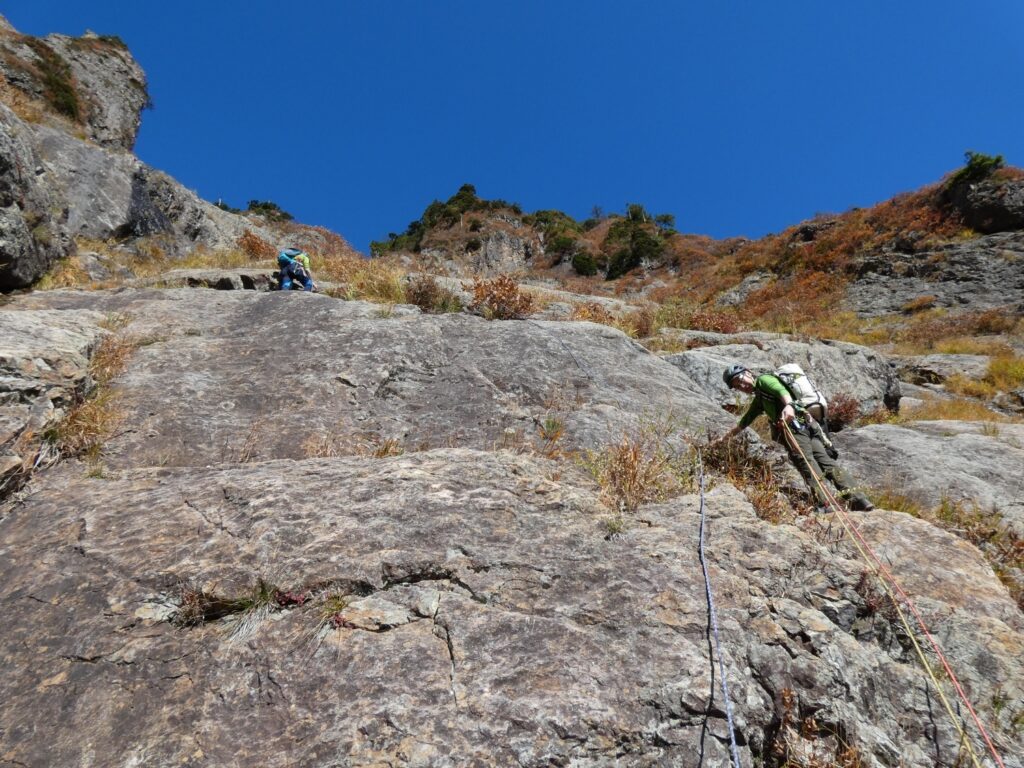Climbing team ascending granite slabs Mt. Maegadake South Wall multi-pitch route
