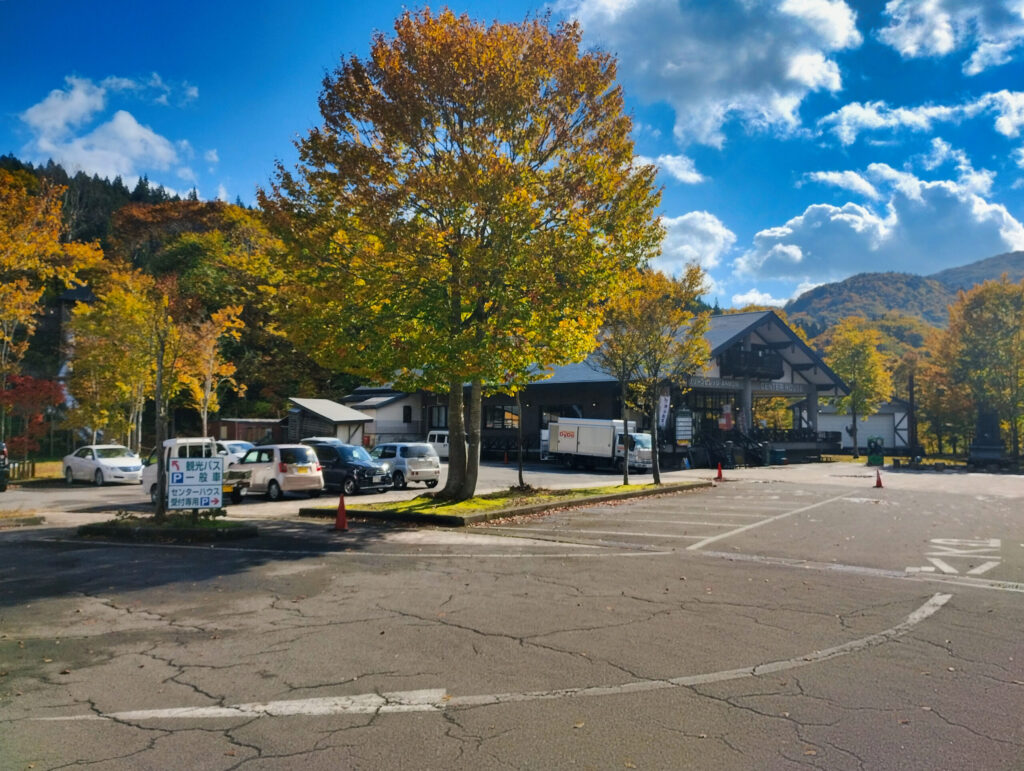 Aqua Green Village ANMON entrance with tour buses in Shirakami-Sanchi, Japan
