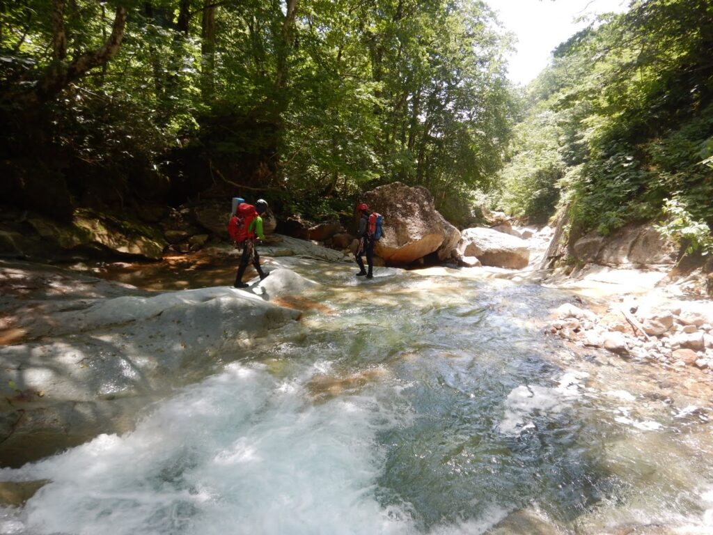 Team walking down Akedori-zawa streambed during descent to Kakkonda Geothermal Power Plant, Hachimantai Japan