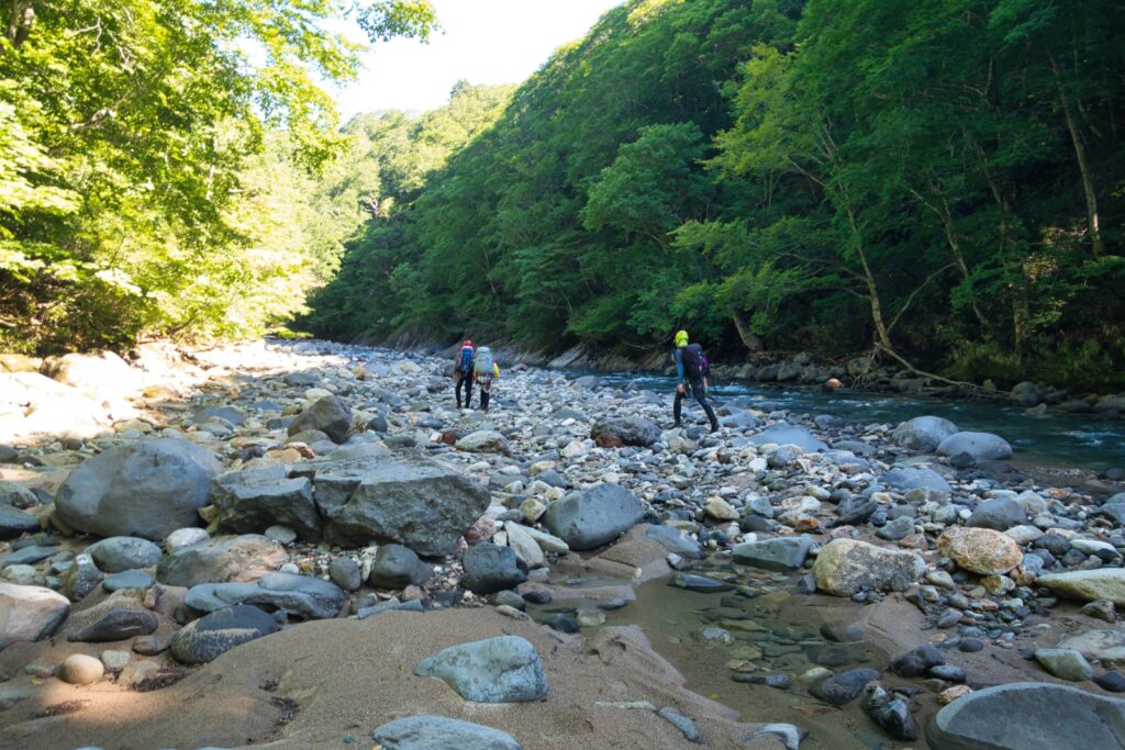 Entering Kitanomata-zawa stream, high water volume at the start of the sawanobori ascent, Hachimantai Japan