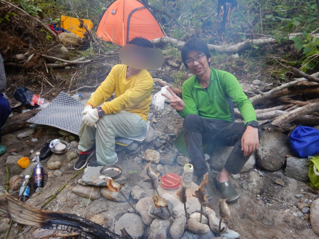 Iwana Japanese char grilled with salt over campfire during bivouac on Kitanomata-zawa stream climbing trip