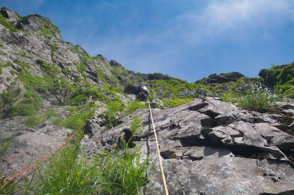 "Alpine climber on buttress section with sparse protection, Central Buttress route"