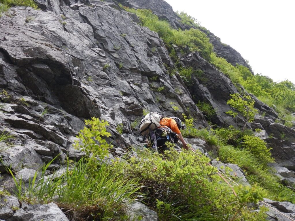  "Climber traversing friable granite face with careful movement, Mt. Tanigawa alpine route"
